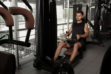 Fototapeta na wymiar Young sporty man training in gym