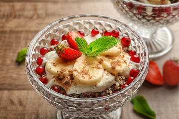 Closeup view of dessert with quinoa, banana and berries on table