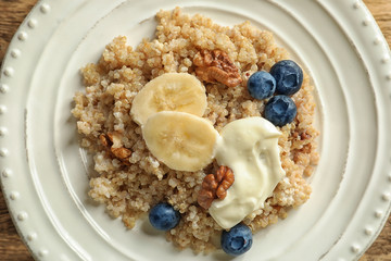 Dessert with quinoa, banana and blueberries on plate