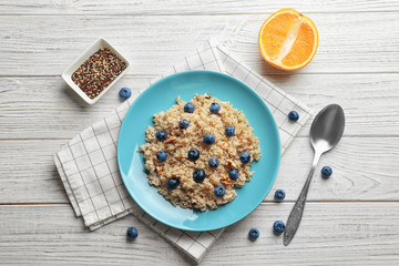Dessert with quinoa and blueberries on wooden table