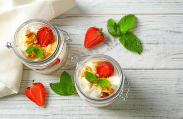 Jars with strawberry pretzel salad on table