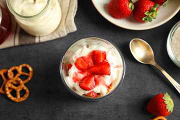 Glass with strawberry pretzel salad on table