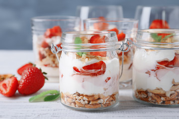 Strawberry pretzel salad in jars on table
