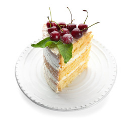 Piece of cake decorated with cherries on white background