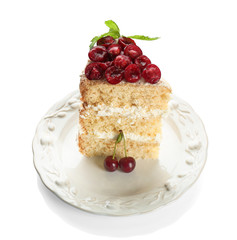 Piece of cake decorated with cherries on white background