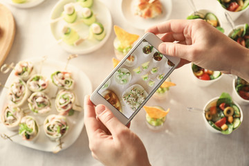 Blogger making photo of food with cell phone