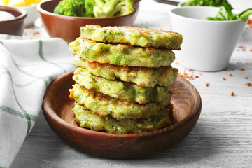 Delicious broccoli pancakes on table