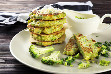 Delicious broccoli pancakes on plate, close up