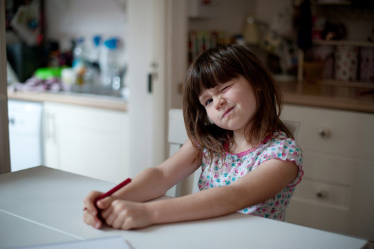 Girl pulling a face at the table
