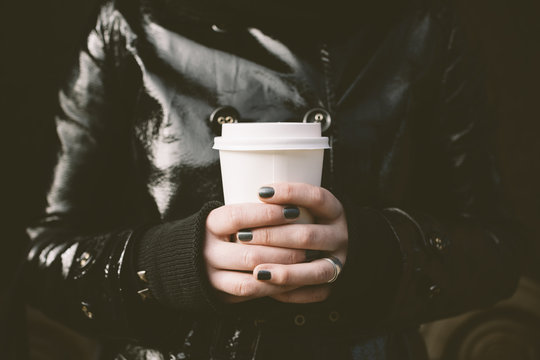 hands of young woman with coffee