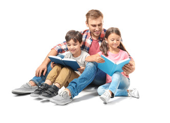 Young man and his little children reading books on white background