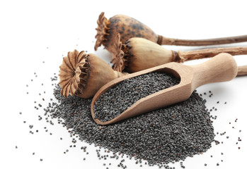 Poppy seeds, dried pods and wooden scoop on white background