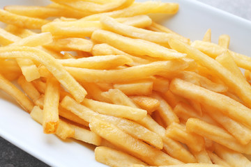 Plate with yummy french fries, closeup