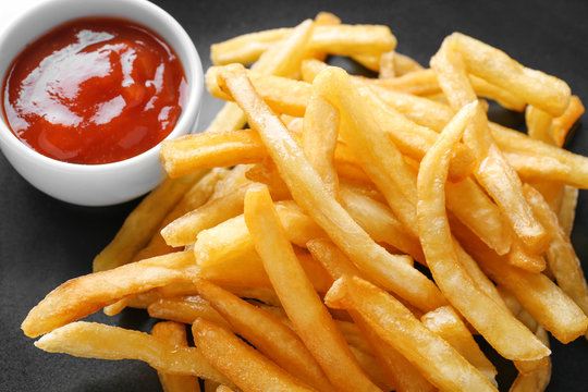 Plate with yummy french fries and sauce, closeup