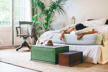 Tired asian woman sleeping in bed.