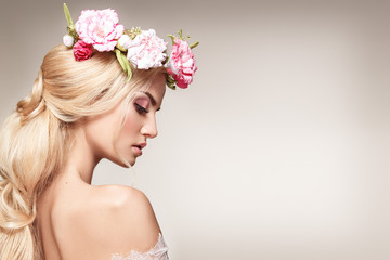 Beautiful woman portrait with long blonde hair and flowers on head. Tender bride.  - 175284642