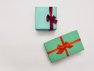 Gift box Trendy styled photo Two stylish multicolored gift boxes with bright ribbons on white...