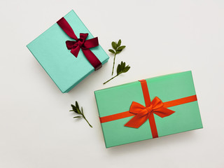 Gift box Trendy styled photo Two stylish multicolored gift boxes with bright ribbons on white background Top view Modern photo template with space for text