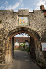 Gated stone archway to Winchester cathedral in Dome alley