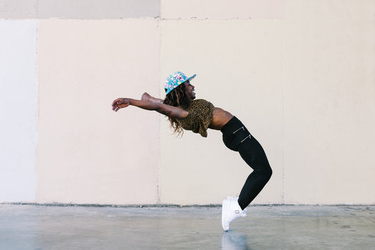 Young african american woman performing street dance in the city.
