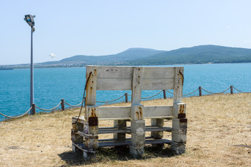 Wooden benches on the high seashore. Seascape.