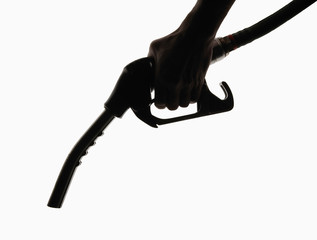 Obraz na płótnie Canvas Hand holding petrol pump in silhouette on white background