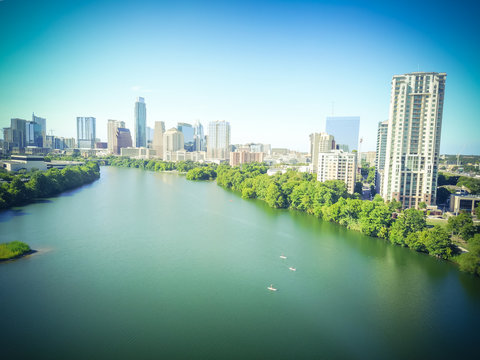 Aerial Green Austin State Capital Of Texas, US With Downtown Skyscraper From Lady Bird Lake. People Paddle Kayak Along Colorado River In Sunny Summer Day. Travel, Architecture Background. Vintage Tone