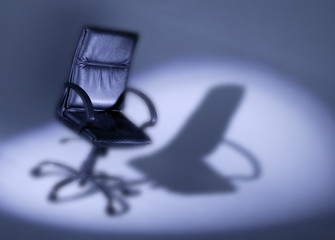 Leather office chair in spotlight