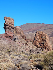 Fototapeta premium towering volcanic rock formations and landscape with mountains in teide national park tenerife