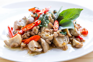 Salted pork with chili & Basil leaves in plate on table, top view