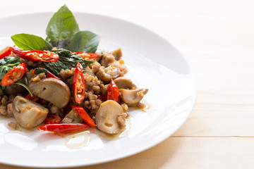 Salted pork with chili & Basil leaves in plate on table, top view