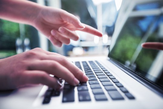 Woman typing computer.
