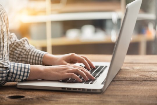 Woman typing computer.