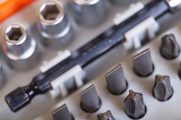 Set heads under the nut. Metal bits and flat-head screwdriver. Nozzles and adapters for...