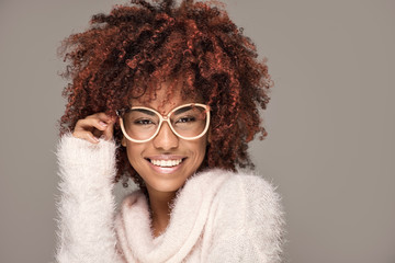 Happy woman with afro hairstyle smiling.