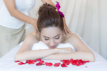 Obraz na płótnie Canvas beautiful and healthy woman enjoying during a back massage in spa salon