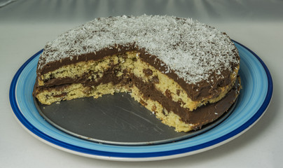Coconut chocolate cake on blue dish
