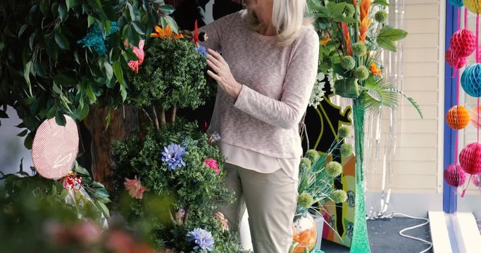 Senior Business Owner Mending her Plants