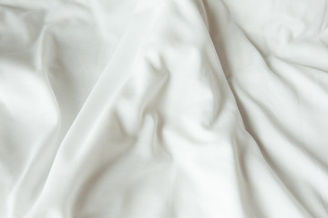 Fototapeta na wymiar Top view of white bedding sheets after wake up in the morning