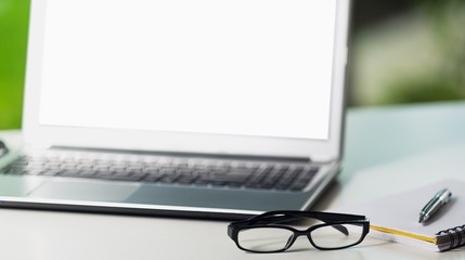 Glasses and laptop on desk.