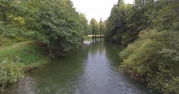 Rising above forest river.
