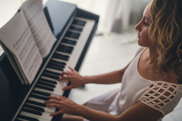 Beautiful woman playing piano