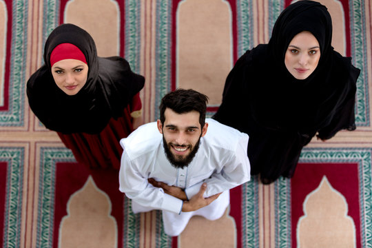 Top View Of Muslim Man And Woman Praying In Mosque