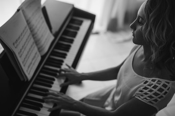 Beautiful woman playing piano. Black and white