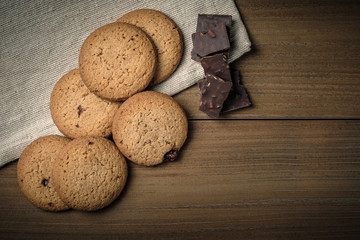 Crunchy malt cookies on dark old wooden table
