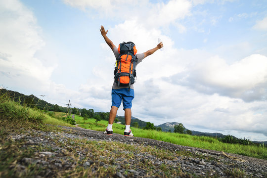 Male backpack happy with journey and nature view.