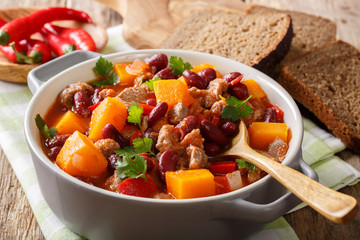 Chili con carne with pumpkin closeup in the pan. horizontal