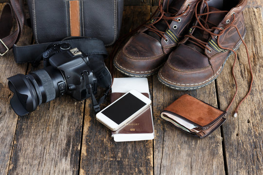 holiday concept, Preparation for travel,smartphone, money, passport,camera on wooden table