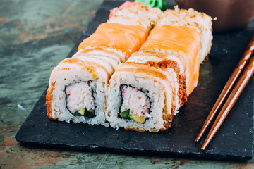 Delicious Assorted Sushi Set Sushi Maki - Eel Maki and Philadelphia Roll Sushi, ginger, wasabi, soy sauce. Copy Space for text. Top view. Sushi background. Asian or Japanese food concept