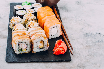 Delicious Assorted Sushi Set Sushi Maki - Eel Maki and Philadelphia Roll Sushi, Roll with avocado and hot fried rolls, ginger, wasabi, soy sauce. Copy Space for text. TAsian or Japanese food concept